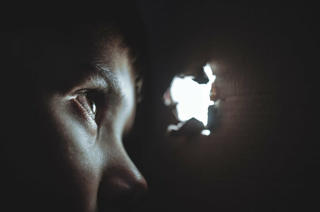 Photo of someone looking through a gap