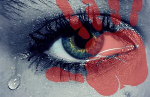 Picture of an eye close up with green eye and red colour depicting tears