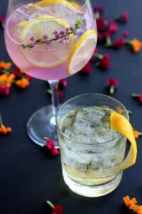Photo of Cocktails on a table with petals around them